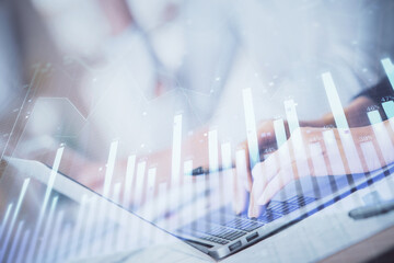 Double exposure of woman hands typing on computer and forex chart hologram drawing. Stock market invest concept.