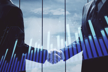 Double exposure of forex graph hologram and handshake of two men. Stock market concept.