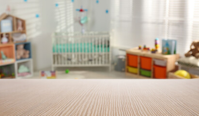 Poster - Empty wooden table in baby room interior