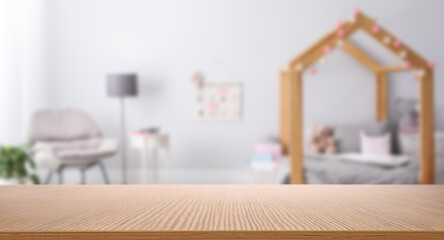 Poster - empty wooden table in baby room interior