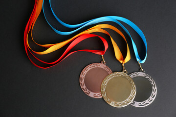 Wall Mural - gold, silver and bronze medals on black background, flat lay. space for design