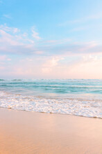 Sandy Beach, Blue Cloudy Sky And Soft Ocean Wave With Warm Sunset Light.