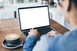 © panitan - computer mockup image blank screen.hand woman work using laptop with white background for advertising,contact business search information on desk at coffee shop.marketing and creative design