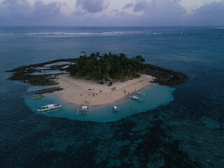 Aerial photos of Guyam Island, a tear-drop shaped island in the Philippine Sea situated around 2 kilometres south-southeast of General Luna municipality. Popular stop for tourists doing island-hopping