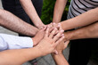 © zequinao - circle of people with hands together on top view showing teamwork unity and friendship