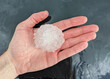 © Dan Ross - Large hailstone measuring greater than two inches (five centimeters) sitting in a person’s hand.