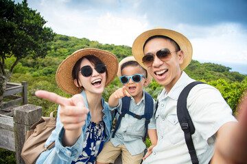 Wall Mural - happy asian Family On Hiking Adventure and taking selfie