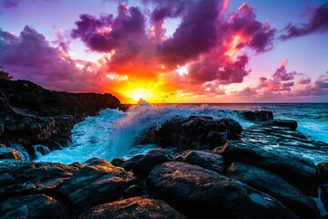 Wall Mural - Beautiful scenery of rock formations by the sea at Queens Bath, Kauai, Hawaii at sunset