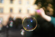© Alex - Soap bubble in the air. Girl makes soap bubbles with a stick in her hand.