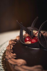 Poster - Vertical closeup shot of a chocolate cake with cherries on top