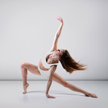 Young Beautiful Graceful Woman With Perfect Slim Sporty Body Dancing And Jumping. Female Beautiful Contemporary Dance. Ease Of Movement, Youth, Grace, Joint Pain Relief And Movement 
