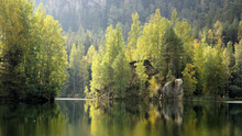 A small rocky island on a mountain lake in The Adršpach-Teplice Rocks, Bohemia, Czech Republic, sandstone formations
