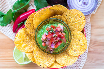 Mexican homemade Guacamole avocado corn nachos chip and tomato salad