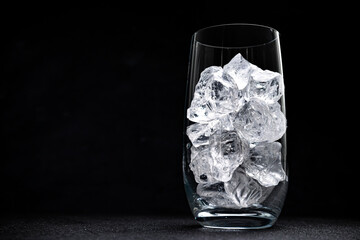 Wall Mural - glass with crushed ice on black background