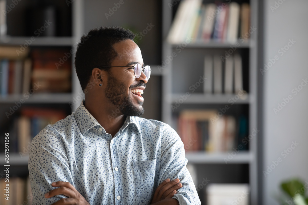 African promoted worker looks in distance thinks of career growth great ...
