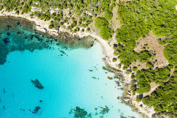 Wall Mural - View from above, stunning aerial view of a rocky coastline bathed by a beautiful turquoise sea. Cala Sabina, Costa Smeralda, Sardinia, Italy.