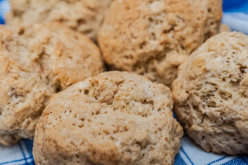 Delicious close up of scones from Eynsham Hall in a blue napkin. Exquisite english baker food. Grade II listed mansion near North Leigh in Oxfordshire, England, United Kingdom. 