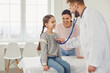 © Studio Romantic - Happy family on a visit to the doctor in the office of a doctor.