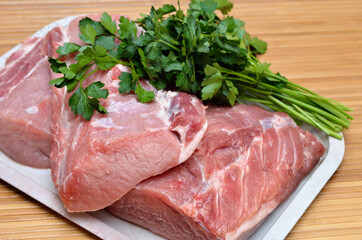 A piece of raw meat on a cutting kitchen table