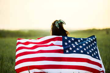 Independence day concept with woman lying down on american flag