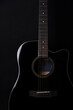 Black acoustic guitar studio shot on black background with copyspace, Guitar is favorite music instrument for hobby.
