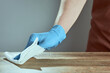 © alexx_60 - A man's hand in medical glove wipes the table with napkin. Background waiter in an apron in blur. Surface treatment.