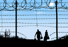 A Man And Woman Are Seen In Silhouette After Breaching A Border Fence On The Southern Border Of The USA. They Have Gone Through A Broken Barbed Wire Fence.