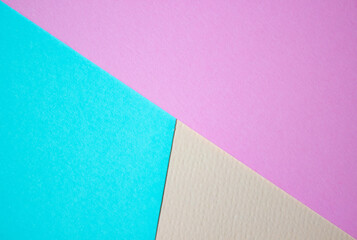 Multicolor background from paper of different colors, pink, blue and yellow. Concept lines, triangles, trapezoid.