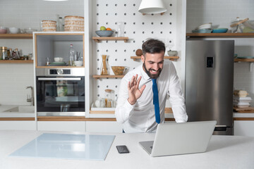 Young freelancer business man working at home say hello to the online conference meeting through the laptop computer to his boss and other colleagues as manager and preparing to present new project