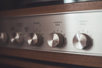 Silver wooden vintage amplifier: Close up of control knobs