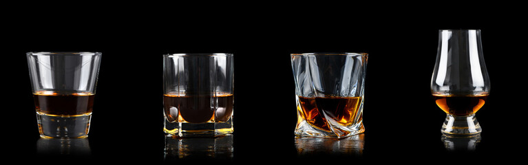 Wall Mural - Set of four glass of whiskey on black background