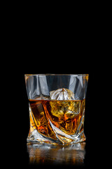 Wall Mural - Glass of whiskey with cube ice on black background