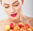 © Svetlana Fedoseeva - Beautiful woman holding a juicy apricots. Perfect skin. Professional makeup.