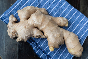 Fresh ginger on rustic background