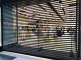 Fototapeta Tulipany - black shutted iron gates of shop in shopping mall due to restrictions of lockdown. Protection measures against coronavirus pandemic. Preparation for opening after ending of lockdown.