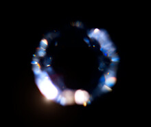 Lens Flare, Abstract Bokeh Lights. Leaking Reflection Of A Glass, Diamond,  Crystal. Jewelry. Defocused Shining Round Shaped Colorful Rainbow Light Leaks, Rays On Black Background