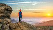 © bilanol - Young child boy hiker standing in mountains enjoying view of amazing mountain landscape at sunrise.