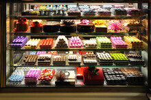 Various Colorful Packages Of Chocolate In A Shop Window