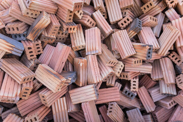 Wall Mural - A lot of red bricks are stacked on the floor. Piles of red construction bricks scattered on the ground.