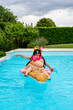 © Marino Bocelli - unny portrait of a woman dressed in Hawaiian costume floating on an inflatable