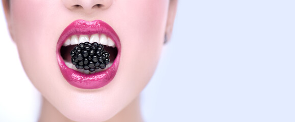 Poster - beautiful model girl eating blackberry, closeup. beauty young fashion woman lips with fresh organic 