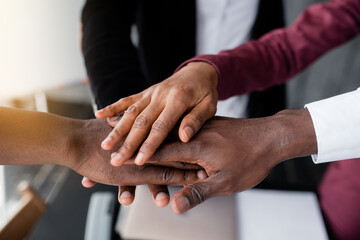 The hands of black people in the center hold each other to unite against racism in large countries. Black lives matter