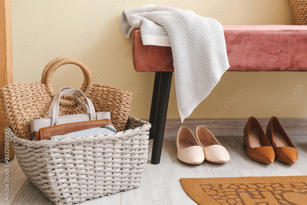 Basket with female accessories and bench in hall