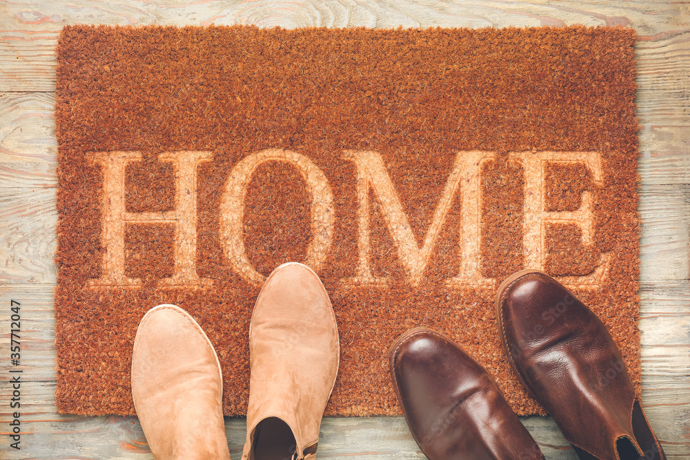 Door mat and shoes on floor
