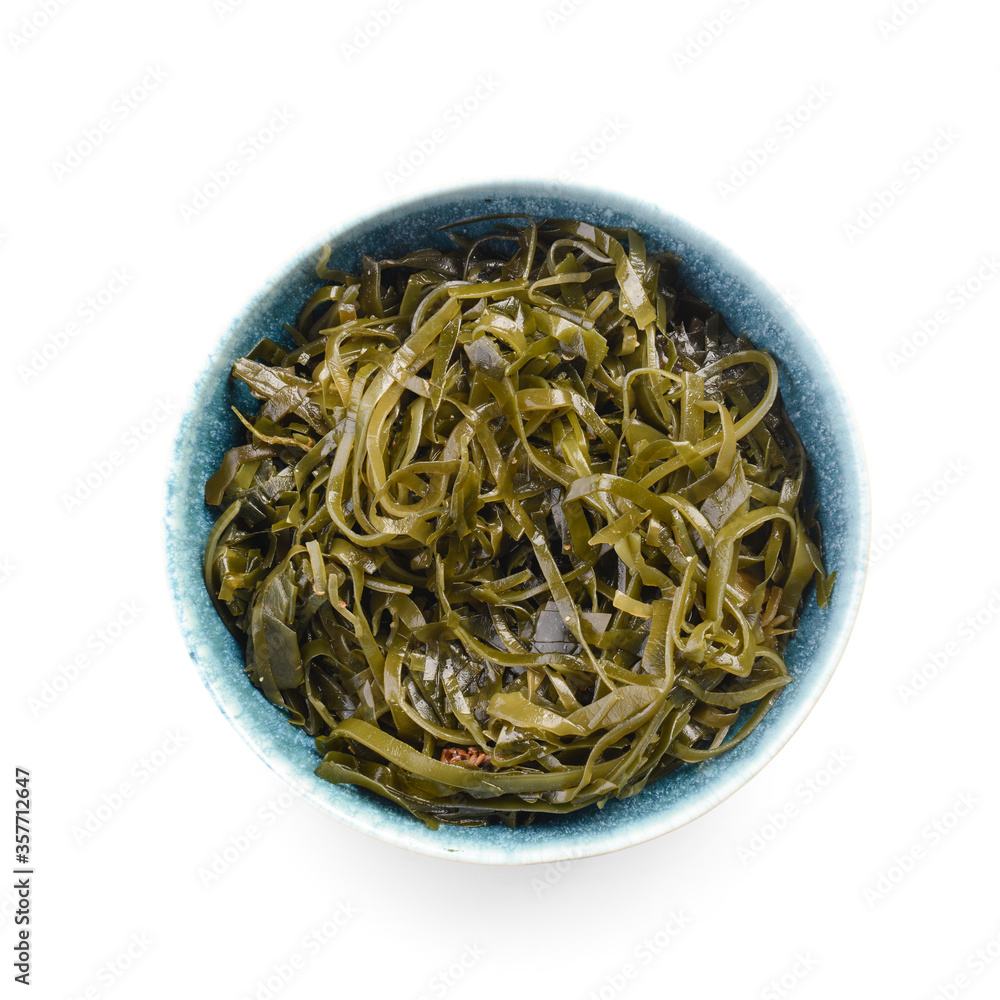 Bowl with tasty seaweed on white background