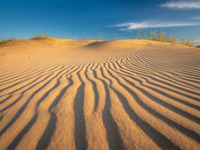 Sand Lines In Sun Lights On Dune In Desert Under Blue Sky With Copy Space