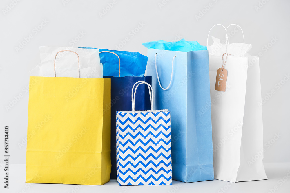 Paper shopping bags on light background