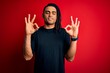 © Krakenimages.com - Young handsome african american afro man with dreadlocks wearing casual t-shirt relax and smiling with eyes closed doing meditation gesture with fingers. Yoga concept.