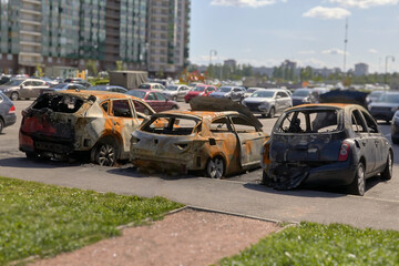 Wall Mural - city burned cars after a fire in one of the city's districts