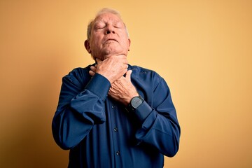 Poster - Grey haired senior man wearing casual blue shirt standing over yellow background shouting suffocate because painful strangle. Health problem. Asphyxiate and suicide concept.